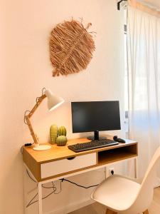 a desk with a computer and a lamp on it at II Central l Kingsizebetten l Nähe Dom und Uni in Aachen