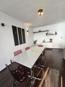 a dining room with a white table and chairs at Sea View over Valletta Harbour 3 bedrooms 2 S4 in Sliema