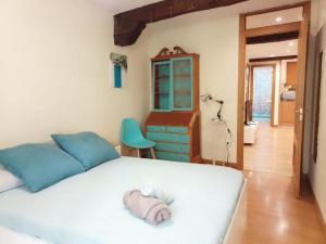 a bedroom with a bed with a stuffed animal on it at Días de Sur in Santander