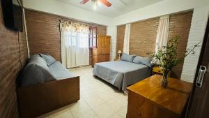 米娜克拉韦罗Lomablanca的一间卧室，里面有一张床、一张沙发和一张桌子