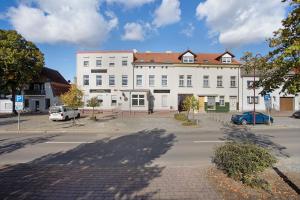 un grande edificio bianco con molte finestre di Fewo zum alten Hotel in Gramzow a Gramzow