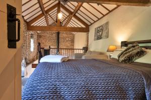 a bedroom with a large bed in a room at Finest Retreats - End Barn at Blackclough Farm in Buxton