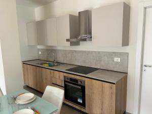 a kitchen with a sink and a stove top oven at Noele in Esine