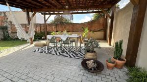 a patio with a table and chairs and plants at La Casita Nazaré - private pool in Nazaré