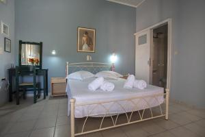 a bedroom with a bed with towels on it at Panorama in Lixouri