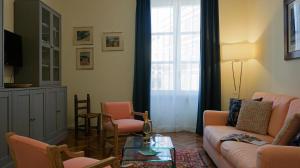 a living room with a couch and chairs at Azuni - Luxury Apartment in Sassari