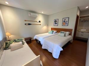a hotel room with two beds at Chalet Monte Boa Vista - Aconchego na Serra com Hidromassagem Exclusiva in Teresópolis