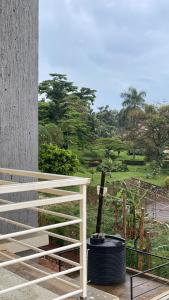 a view of a garden from the balcony of a house at Modest Spacious Apartment in Kampala