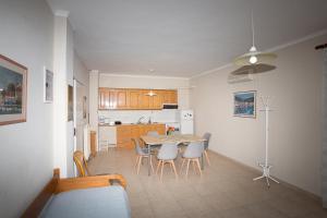 a kitchen and dining room with a table and chairs at Panorama in Lixouri