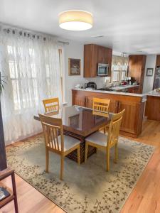 a kitchen and dining room with a table and chairs at Elegant Cambridge Room, Short Walk to Harvard in Cambridge