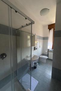 a bathroom with a shower and a sink and a toilet at Pantone Cremisi-Seregno Center in Seregno +10 photos