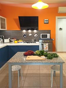 a kitchen with a table with vegetables on it at Tedimo Mare in Marina di Ragusa