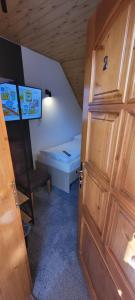 a door to a room with a bed in a attic at Ferdinand Penzion in Moldava nad Bodvou +26 photos