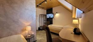 a room with two beds and two tables and two lamps at Ferdinand Penzion in Moldava nad Bodvou