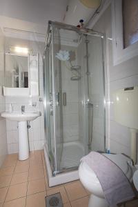 a bathroom with a shower and a toilet and a sink at Panorama in Lixouri +45 photos