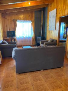a living room with a couch and two couches at Cabañas en caburgua in Pucón