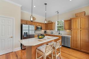 a kitchen with wooden cabinets and a large island at 3 Bdrm 3 Bath Vacation Home North Litchfield Beach in Pawleys Island