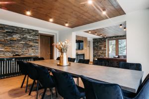 a dining room with a large table and chairs at Grand Chalet Lacu Rosu in Lacu Rosu