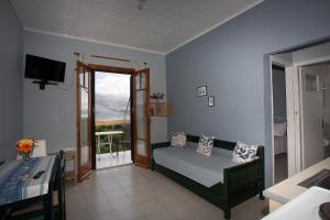 a living room with a couch and a balcony at Panorama in Lixouri