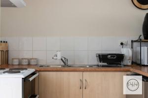 a kitchen with a sink and a counter top at Beachside Retreat in Bunbury