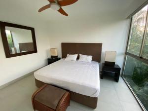 a bedroom with a large bed and a mirror at Luxury Condo Mareia Ixtapa 101 in Ixtapa
