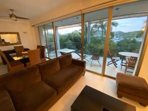 a living room with a couch and a table and chairs at Luxury Condo Mareia Ixtapa 101 in Ixtapa