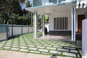 a patio of a house with a fence at Dutch Heaven - Luxury Rental Villa Near Cochin Airport in Nedumbassery