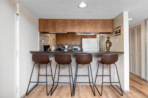 a kitchen with a counter and bar stools at Highlands 05 with Wintergreen Advantage in Wintergreen