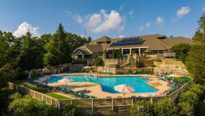 a large swimming pool in front of a house at Highlands 05 with Wintergreen Advantage in Wintergreen