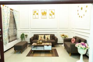a living room with two couches and a coffee table at karangjambe tnbts in Gadang