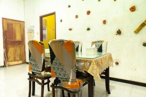 a table and two chairs with a table and a mirror at karangjambe tnbts in Gadang