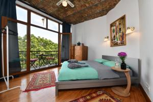 a bedroom with a bed and a large window at Galata Tower Is Almost In Your Bedroom And In The Balconies Rooftop Terrace with Golden Horn View in Istanbul