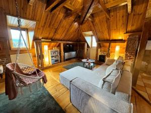 a living room with a couch and chairs in a house at Un Chalet dans la ville in Colmar