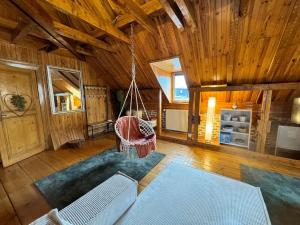 a living room with a swing in a cabin at Un Chalet dans la ville in Colmar