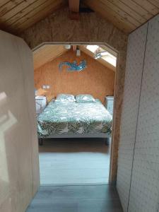 a bedroom with a bed in a small room at La Cachotière du Lac in Giffaumont +12 photos