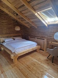 a bedroom with a bed and a skylight at Cabana 278 in Moieciu de Jos