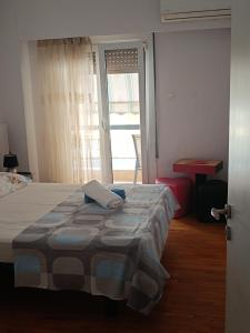 a bedroom with a bed and a door with a window at Classical beauty near Acropolis! in Athens