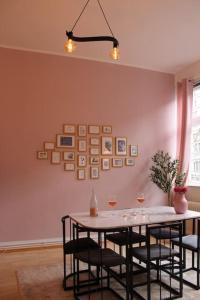 a dining room with a table with chairs and pictures on the wall at Aldstadt 2,5 Room Modern Elite Location Balcony in Hannover