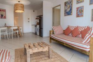 a living room with a couch and a table at Cactus appartement T4 in Saint-Denis