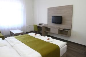 Postel nebo postele na pokoji v ubytování Hotel Palác Elektra