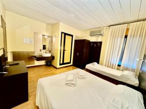 Postel nebo postele na pokoji v ubytování Hotel Guidi