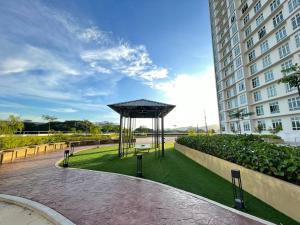 a pavilion in a park next to a building at the Anderson Ipoh 2BR by Goswell in Ipoh