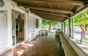 an empty porch of a house with a wooden ceiling at 2 Bedroom Nice Home In Monterosso Almo in Monterosso Almo