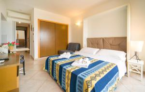 a hotel room with a bed with towels on it at Mono 2 in Lido di Mondello