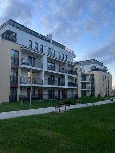 a building with two benches in front of it at NexuS Apartments in Sibiu