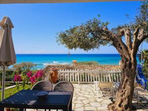 a table and chairs with a view of the ocean at Corfu Glyfada Beach Apartment 24 in Glyfada