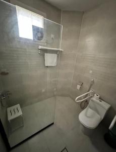 a bathroom with a toilet and a shower stall at فندق جارة الغيم للاجنحة الفندقية in Fayfāʼ