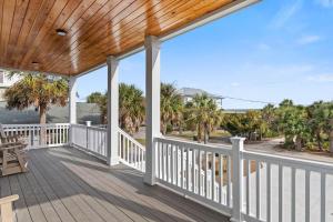 a wooden porch with a view of the ocean at It's Nautical Nonsense Oceanview 4 bedroom, 4 bath in Pawleys Island