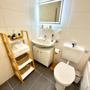 a small bathroom with a toilet and a sink at M&D Apartments nähe Stadion mit Klimaanlage - Netflix - Küche - Sunset View - Balkon in Kaiserslautern +15 photos