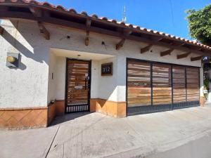 a house with two garage doors on it at Bonito Depa céntrico in Jardines de la Hacienda